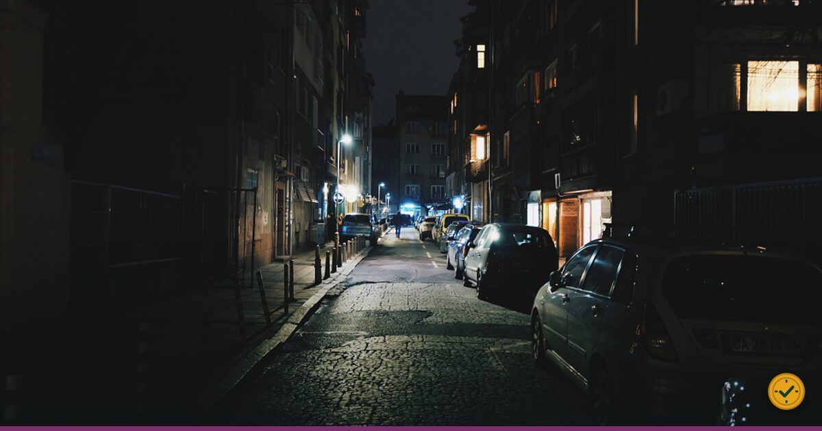 Cars parked along a street at night
