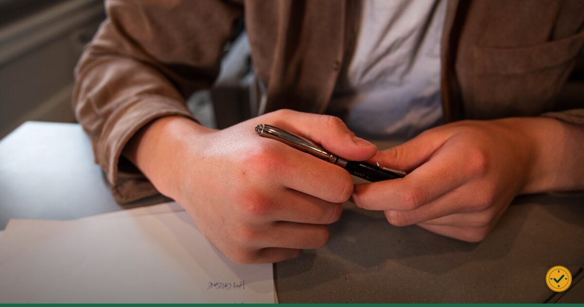 Hand writing with a pen on paperwork