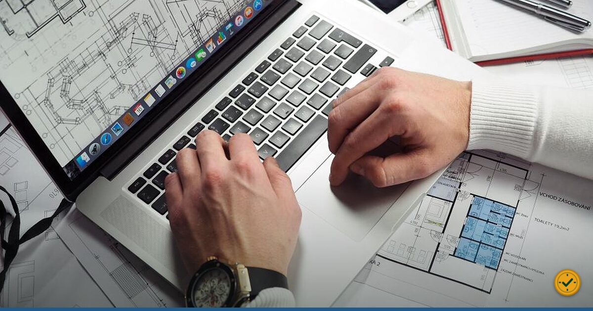 Hands typing on a laptop keyboard
