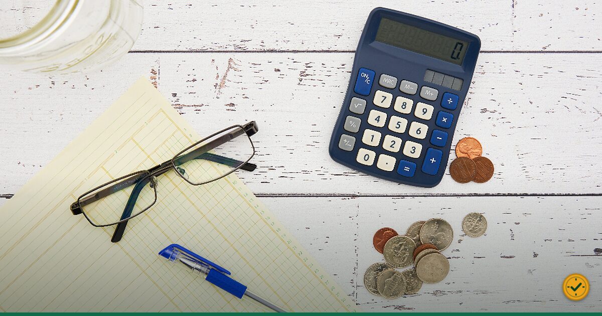 Reading glasses and a calculator on a desk